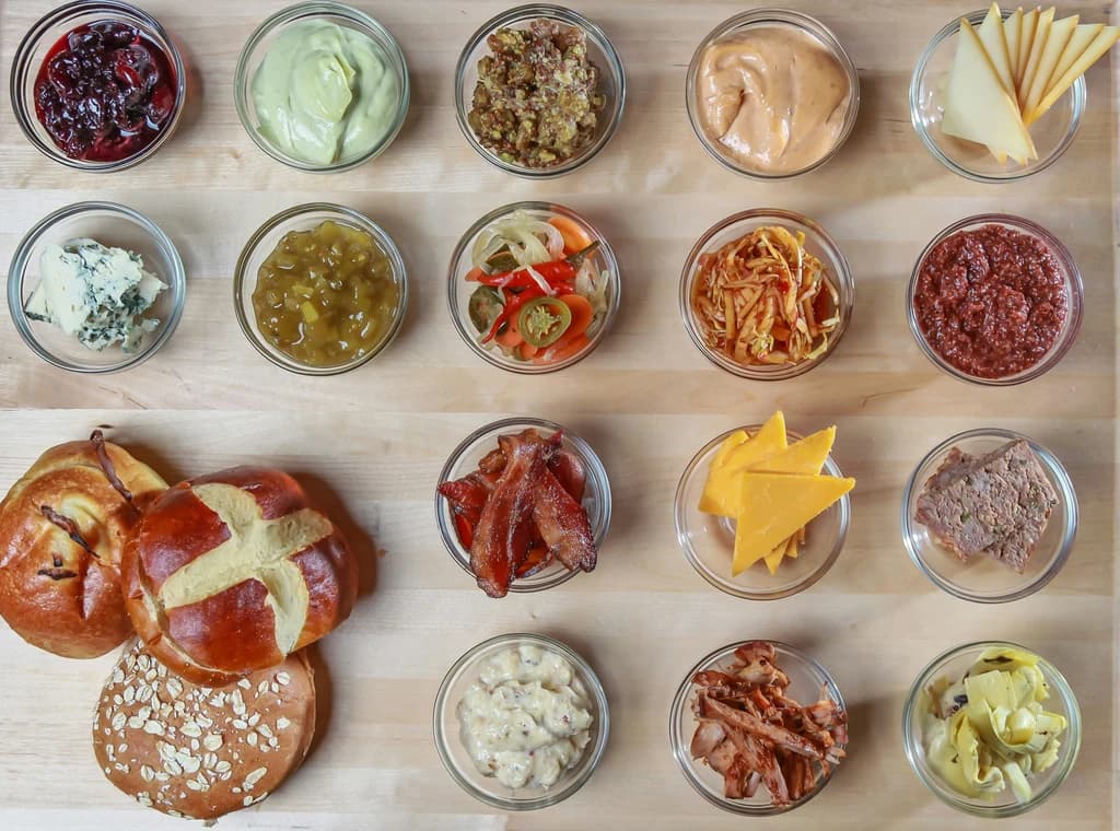small bowls with different cheeses, meats, and sauces