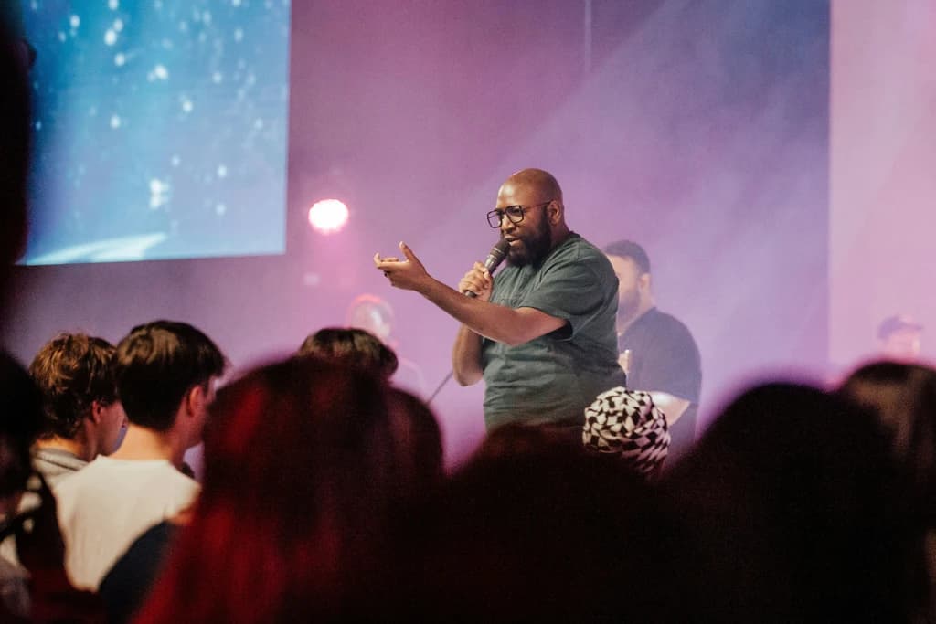 a man speaking infront of a crowd