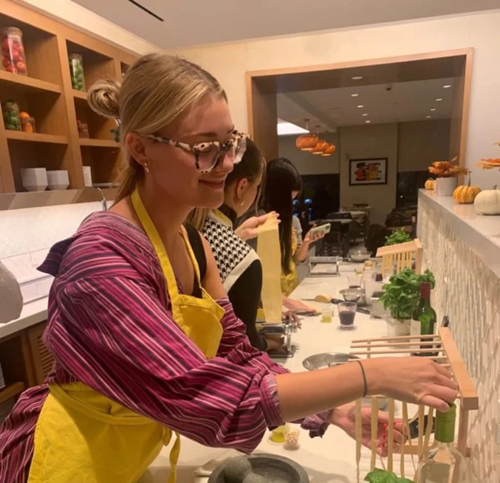 a person miking past with seasoning by hand with ingredients around them
