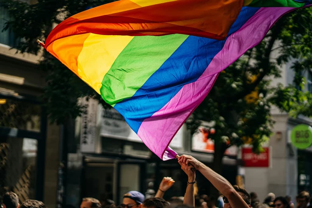 someone waiving a pride flag