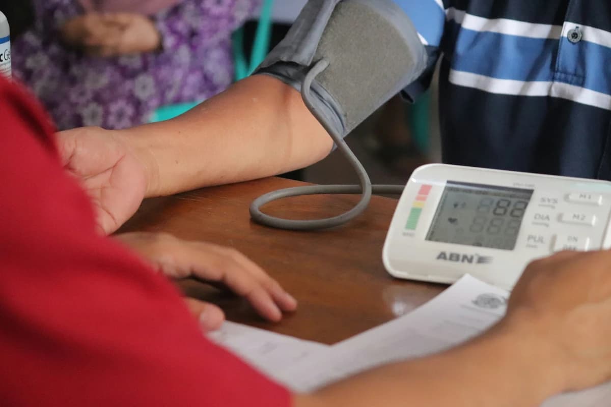 Person getting their blood pressure measured with an automatic blood pressure monitor.