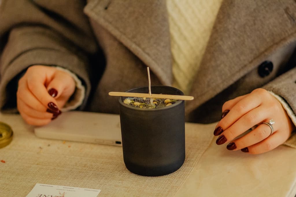 a candle madin in a jar with the wick sticking out