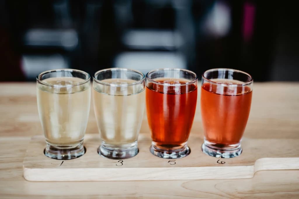 a line of ciders on a bar top