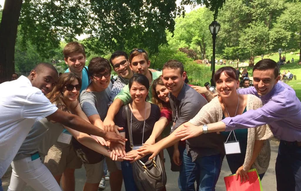 a group of people putting their hands together in a circle