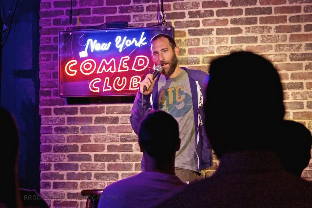 a comic standing in front of a crowd