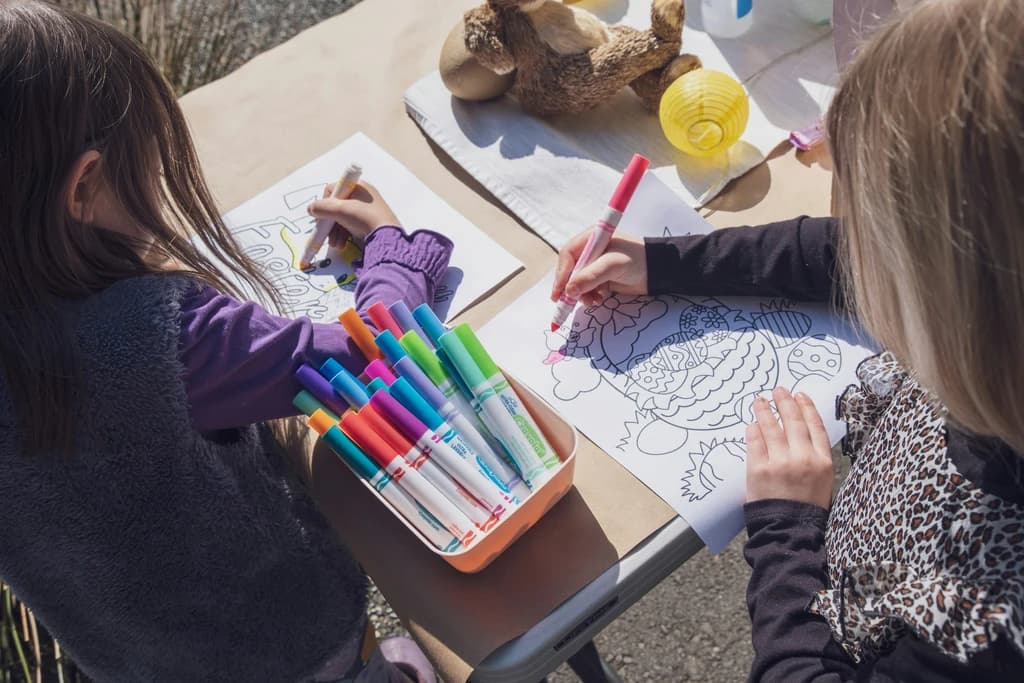 children sitting at a table coloring