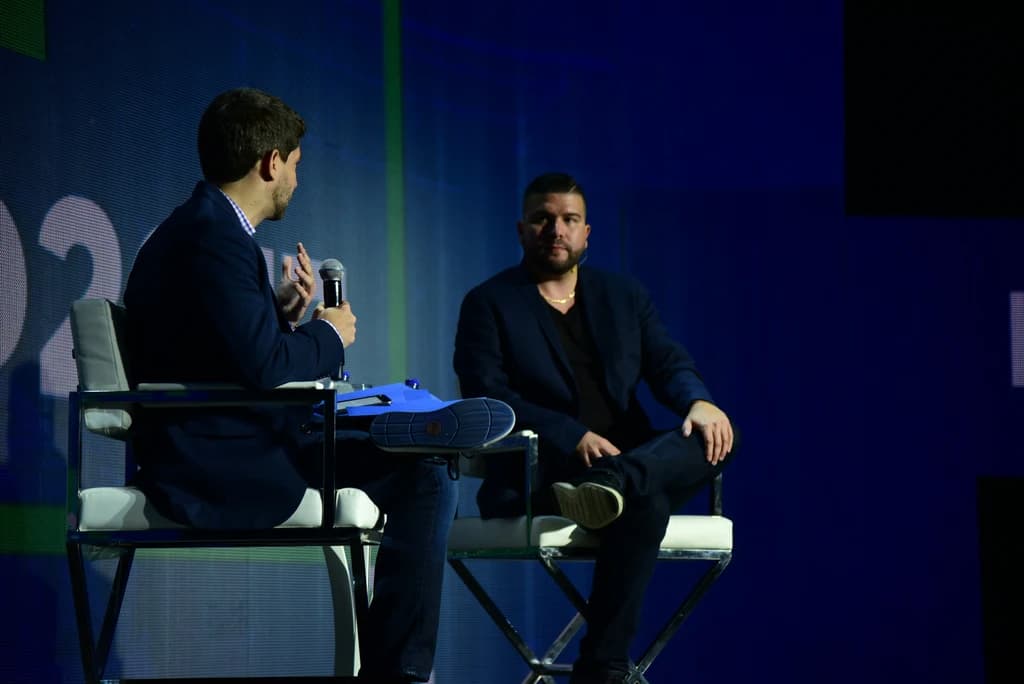 two people sitting on a stage and talking