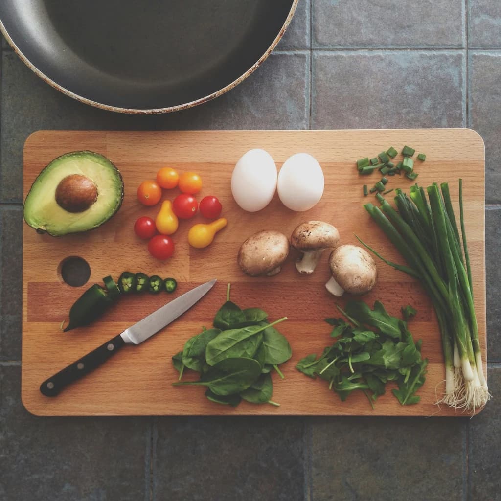 a cutting board with produce cut up on it