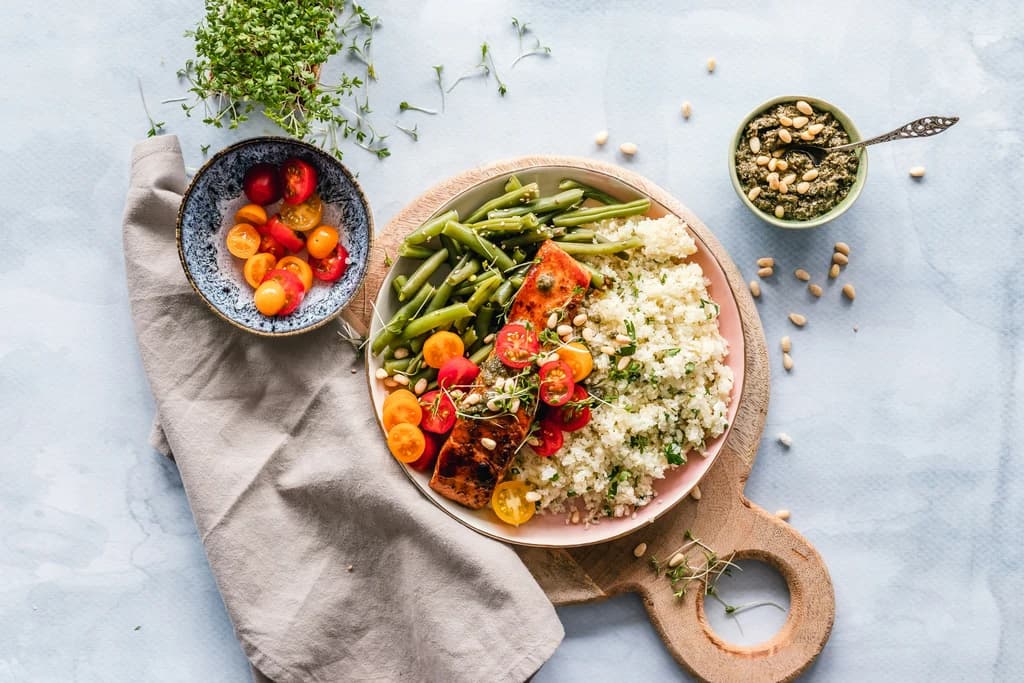 a dish of seasoned vegetable and rice in a dish on a cutting board