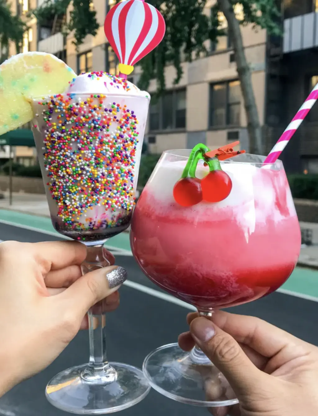 A group of friends sitting together at a restaurant with large ice cream cocktails in hand, enjoying the fun atmosphere of an ice cream bar.