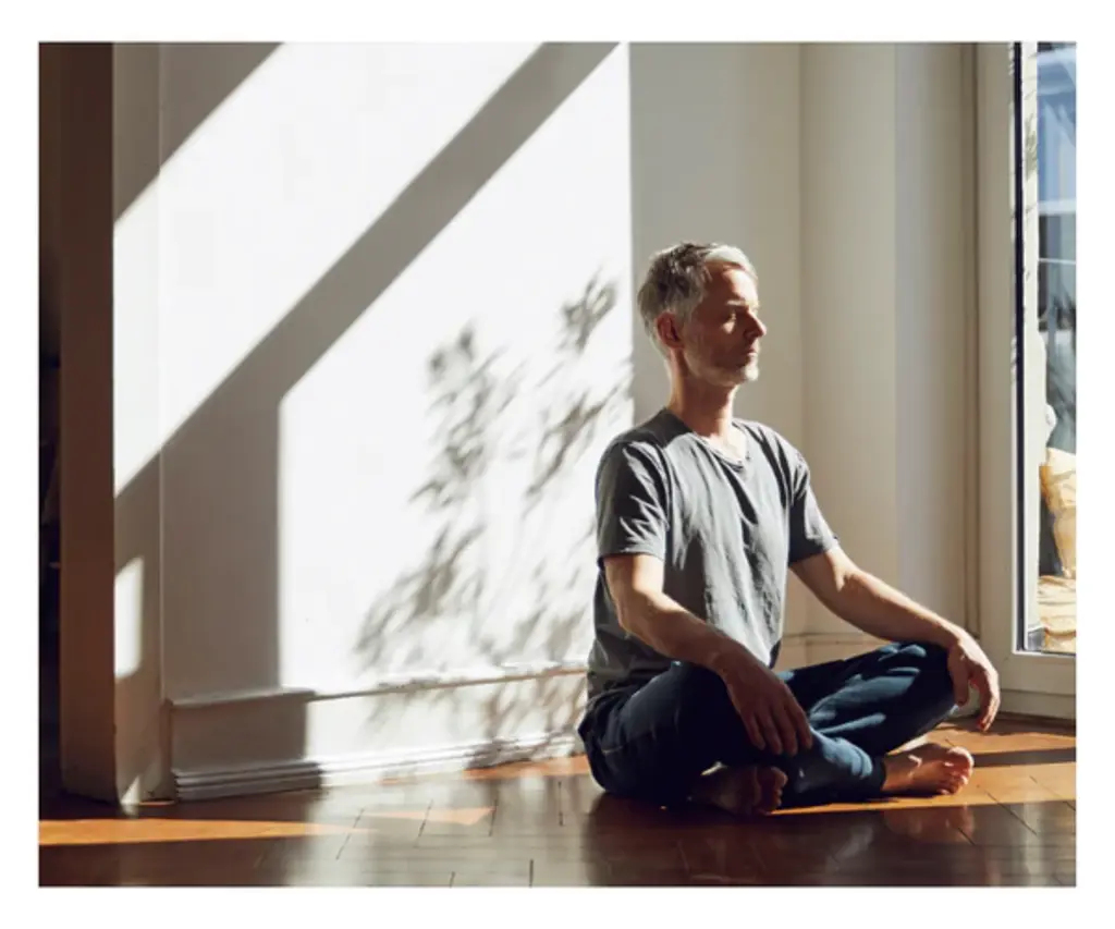 a person sitting on the floor meditating