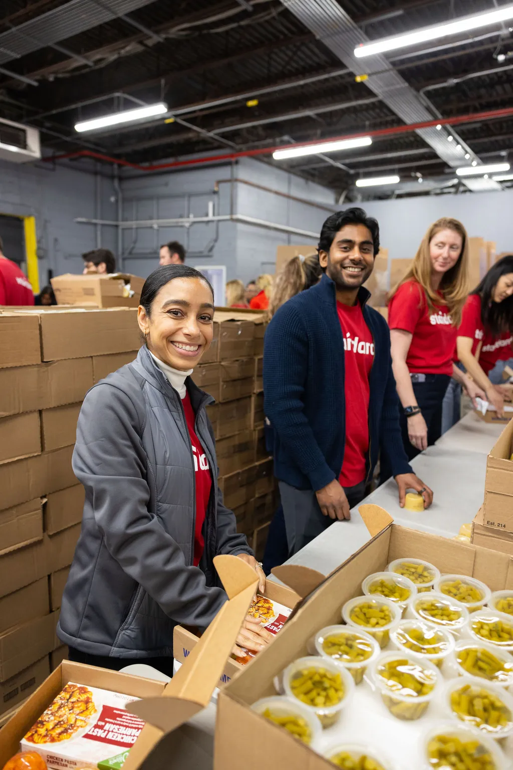 people loading boxes of meals into a truck