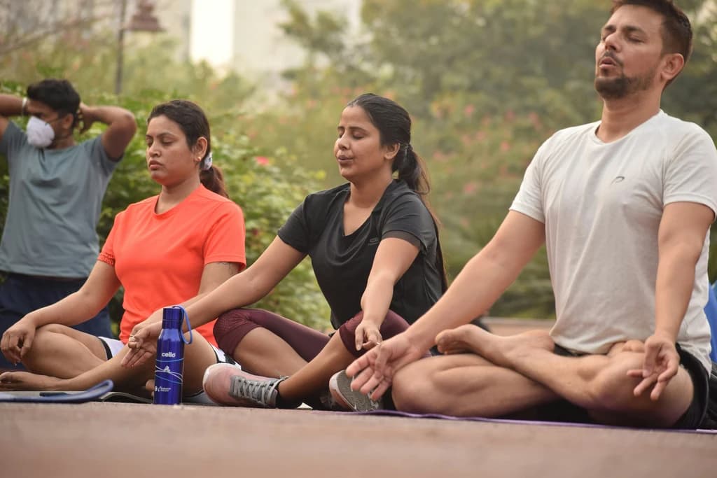 a row of people meditating and performing breathing exercises