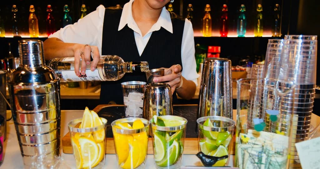 a close up of somone mixing a drink with different ingredients in front of them