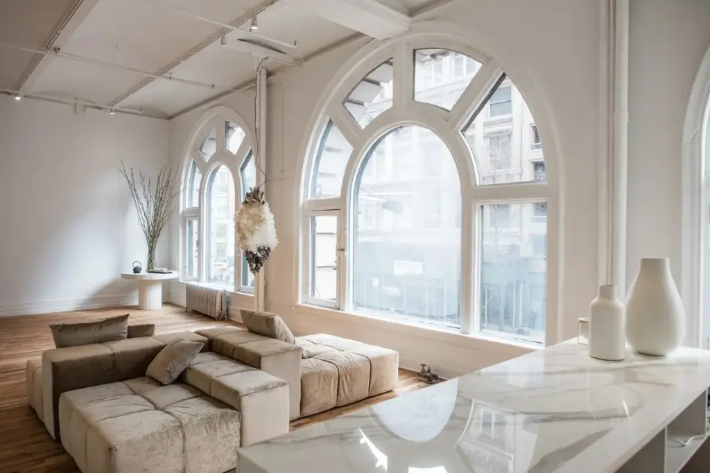 a yoga studio with cushions and large windows