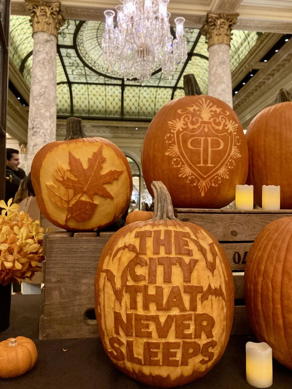 Two Jack-o'-lanterns with sinister grins, their faces lit up brightly in the dark, reflecting on the surface below.