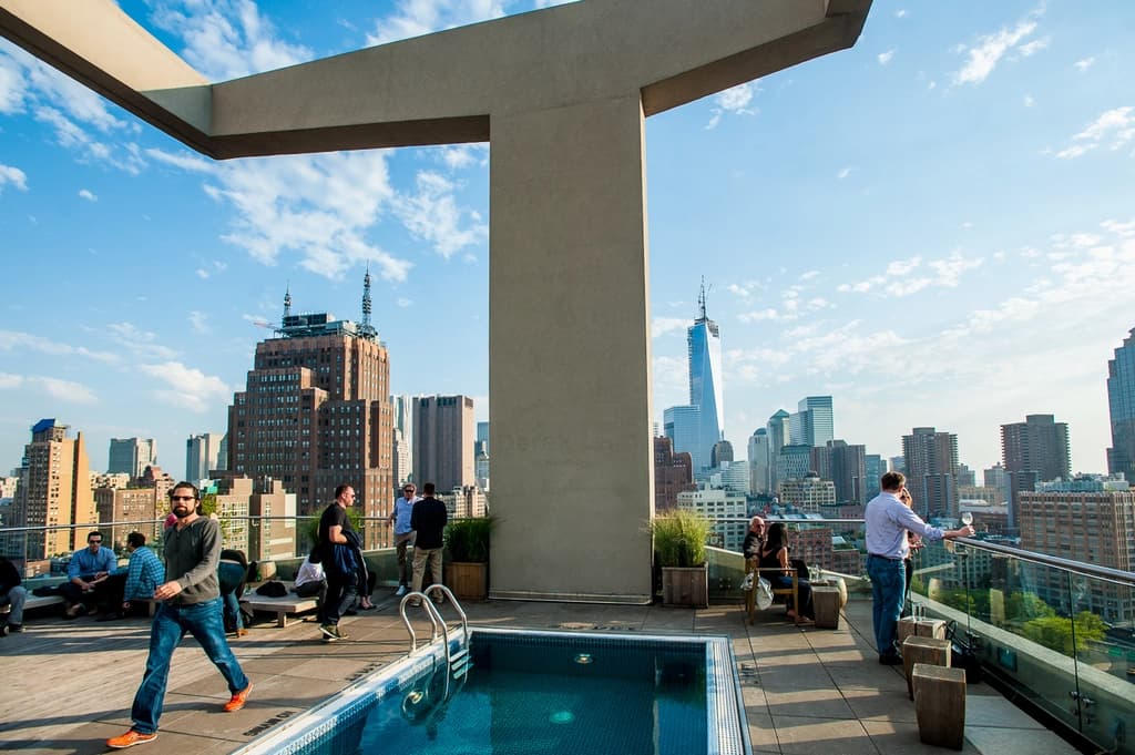 roof top pool with seating and view of the city