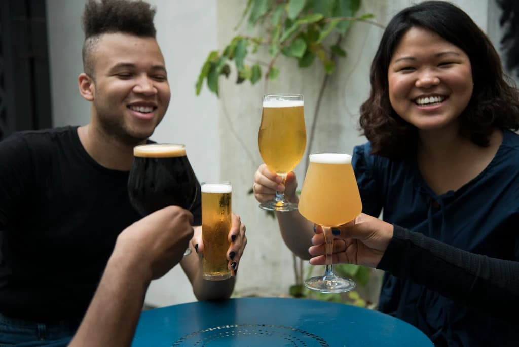 people cheersing different glasses of beer