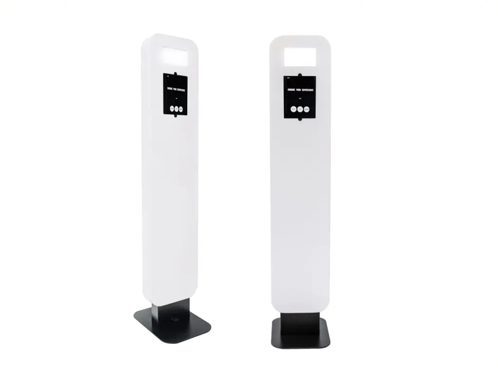 A white, modern photo booth with a glowing ring light, set against a minimalist interior.
