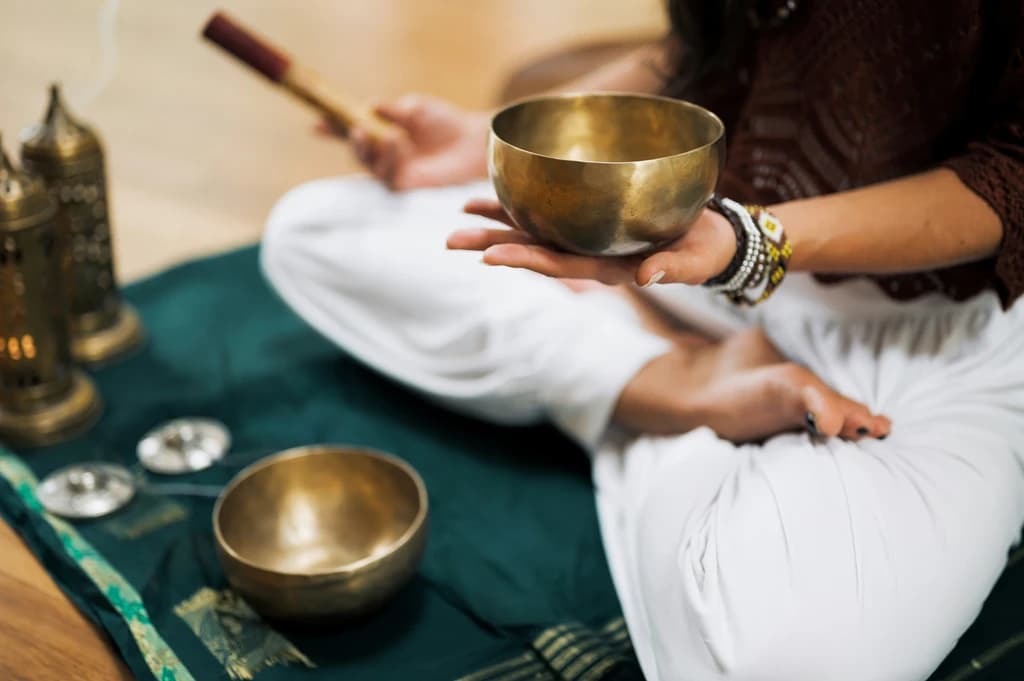 a close up of someone holding a sound bowl