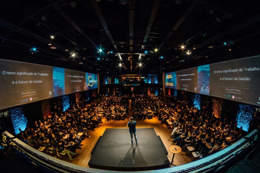 a speaker on stage in front of a large audience