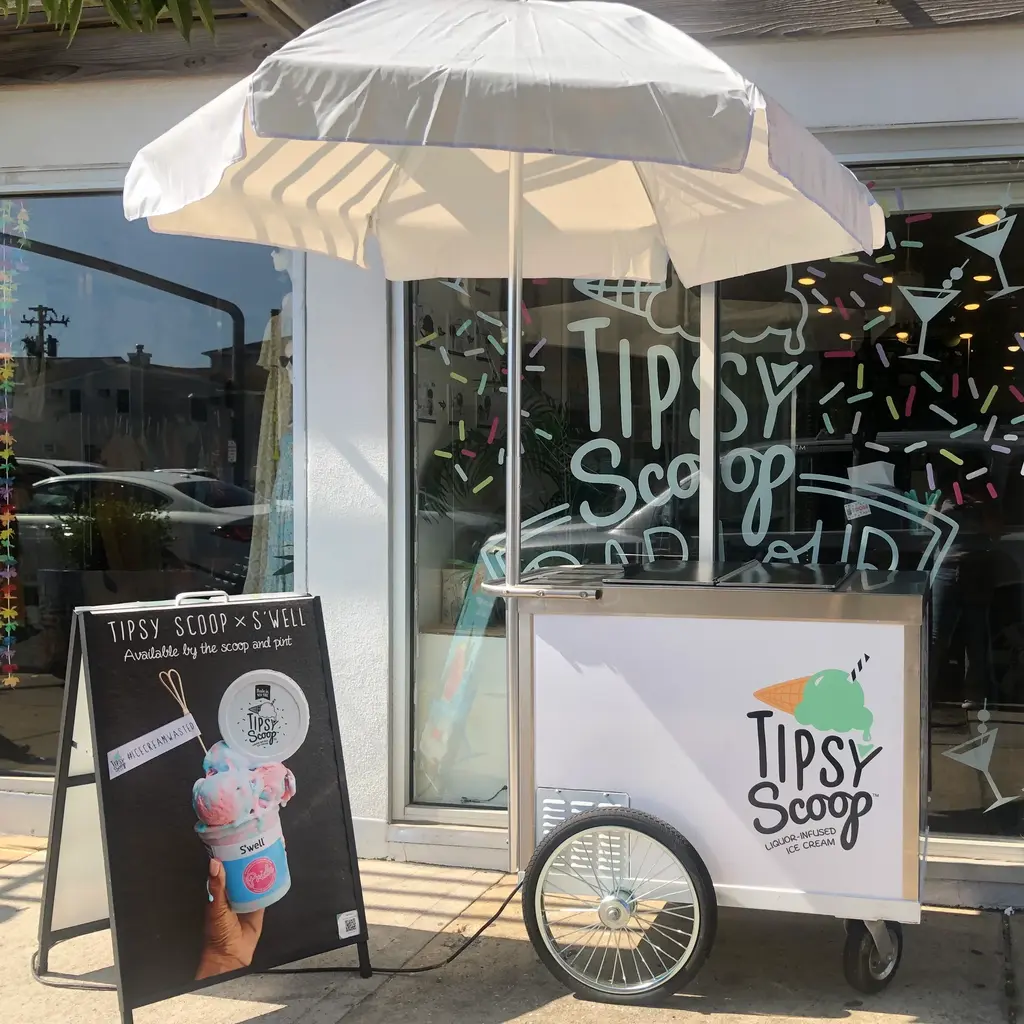 Tipsy Scoop ice cream cart featuring a variety of alcohol-infused ice creams.