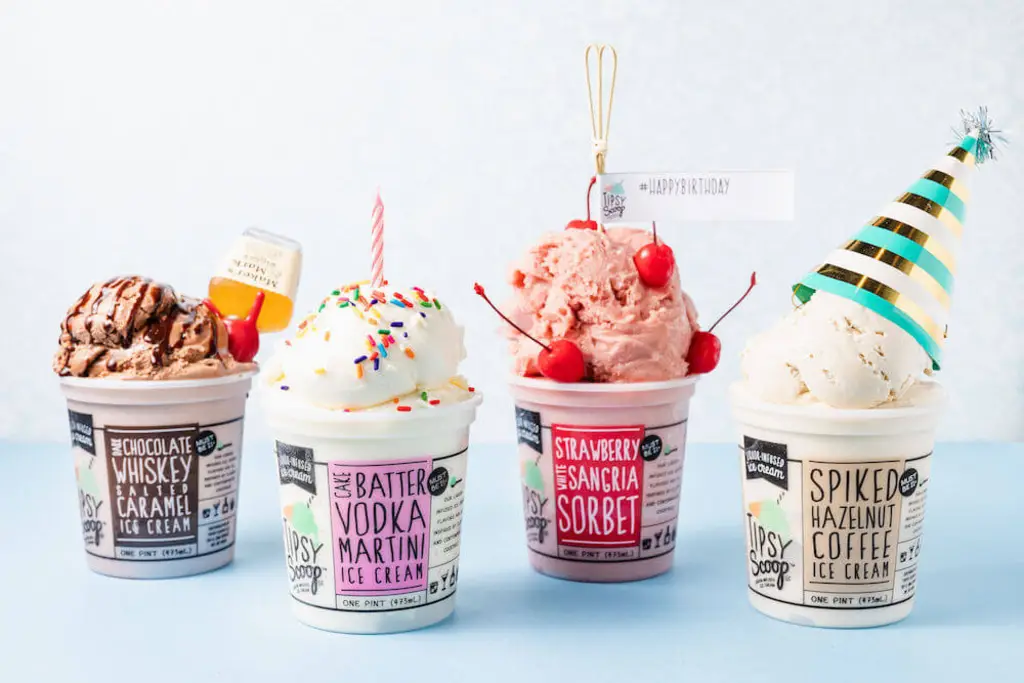 Close-up of Tipsy Scoop ice cream flavors in mini plastic cups.
