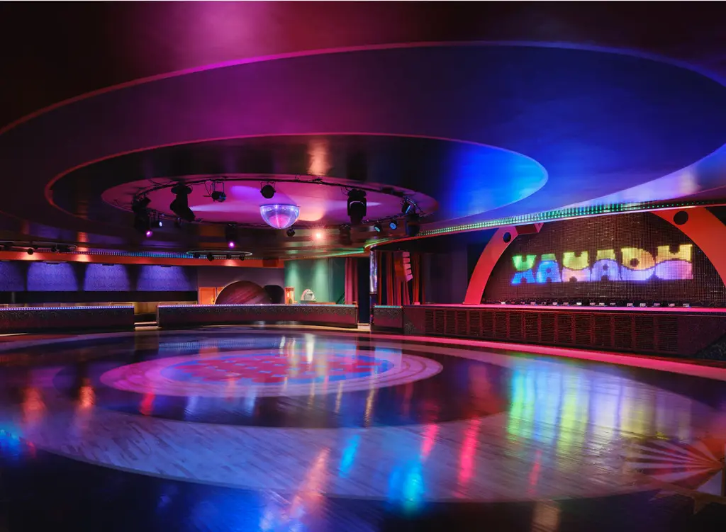 A vibrant, colorful roller rink with a disco ball and dynamic lighting, creating an energetic and retro atmosphere.